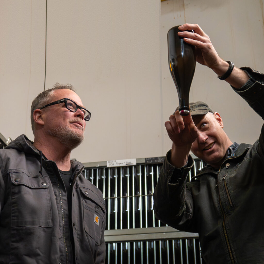 Andy Lytle and Andrew Davis examine bottles for disgorgement.